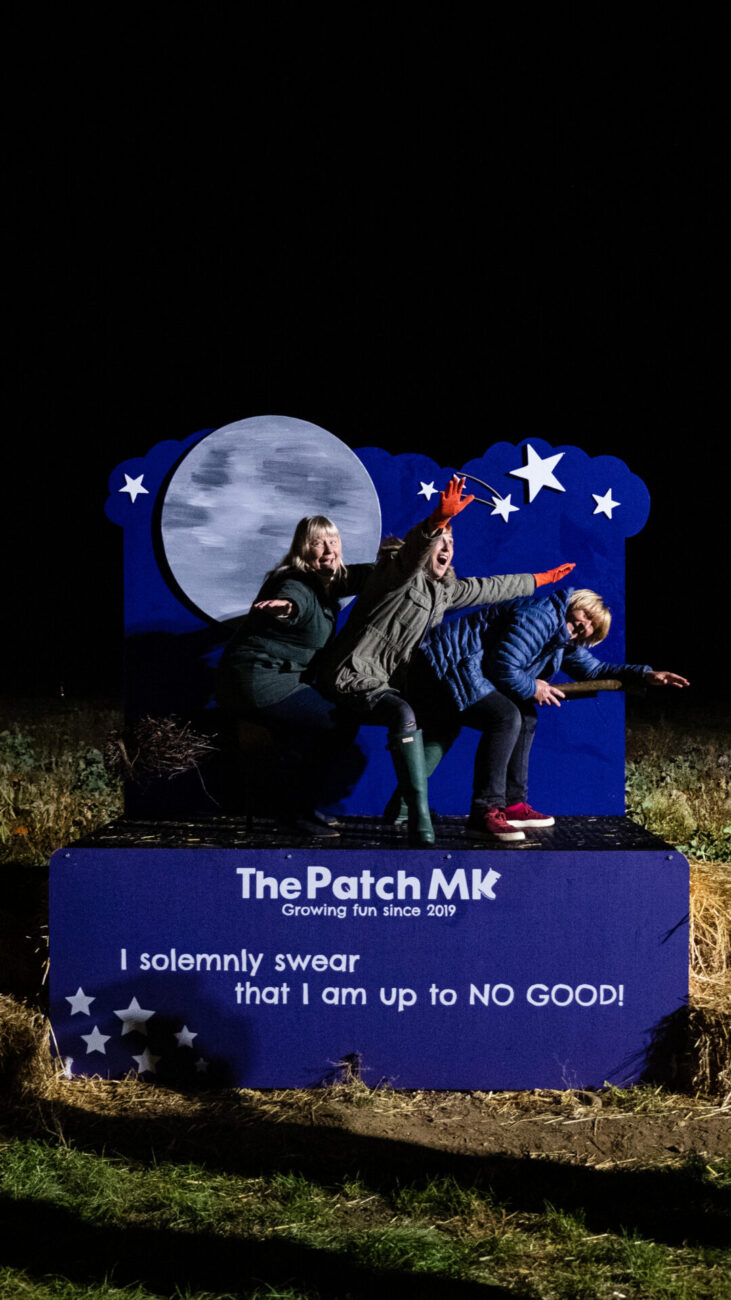 3 ladies on a broom at photo-op at the patch mk